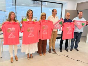 Grupo de seis personas sosteniendo camisetas rosas con el lema "Guadalajara juntos contra el cáncer" en Guadalajara.