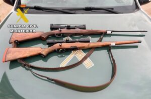 Dos rifles de caza sobre el capó de un coche de la Guardia Civil en Guadalajara.
